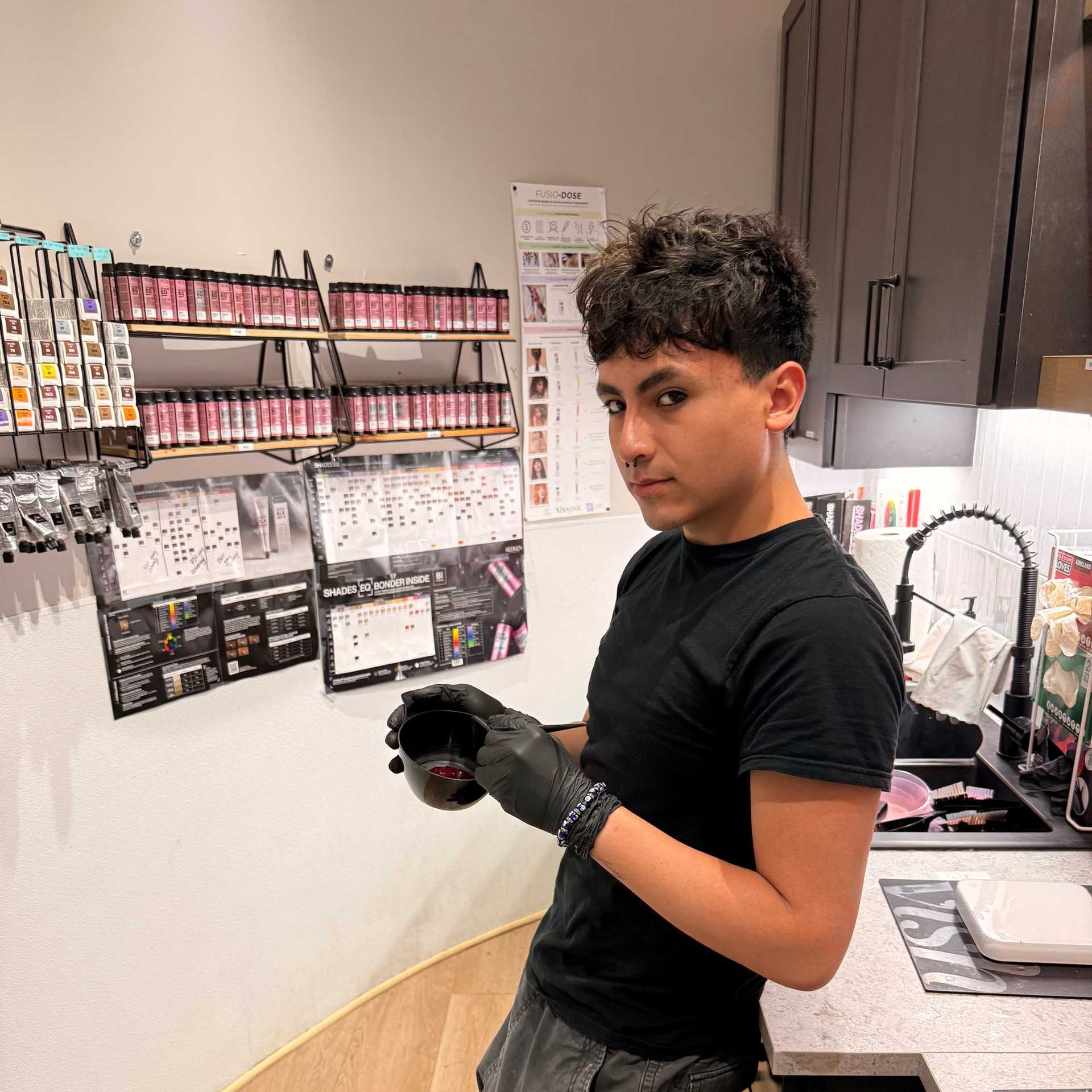 Portrait of Enzo Sejas, a professional stylist at Salon Khouri, showcasing their expertise and style.