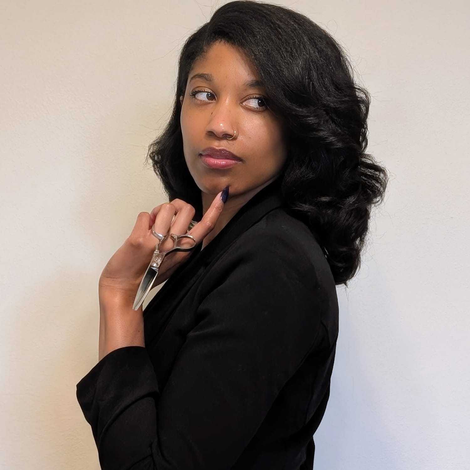 Portrait of Teesha Bushrod, a professional stylist at Salon Khouri, showcasing their expertise and style.